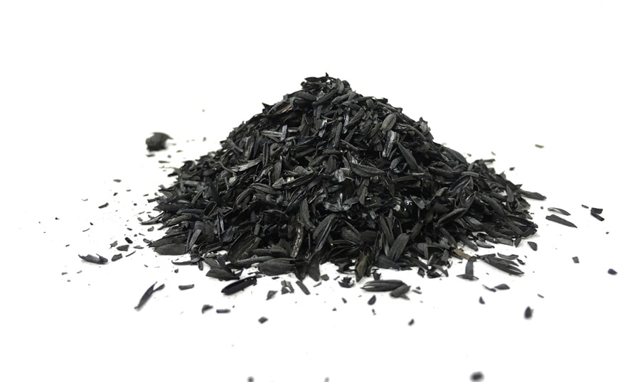 photo of a pile of rice husk biochar on a clean white surface